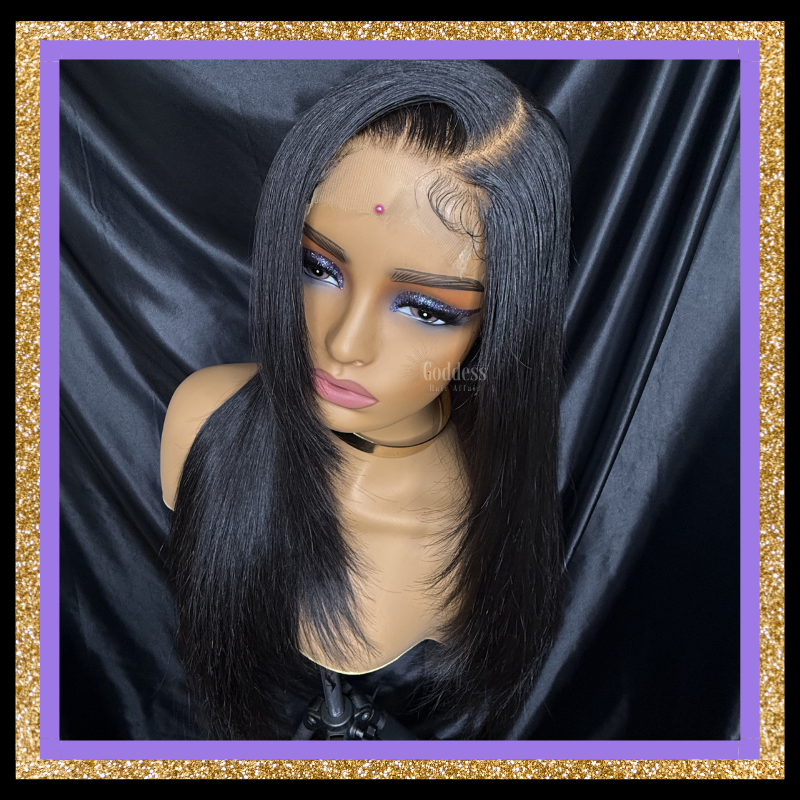 Black lace front wig on a mannequin head with a dark background