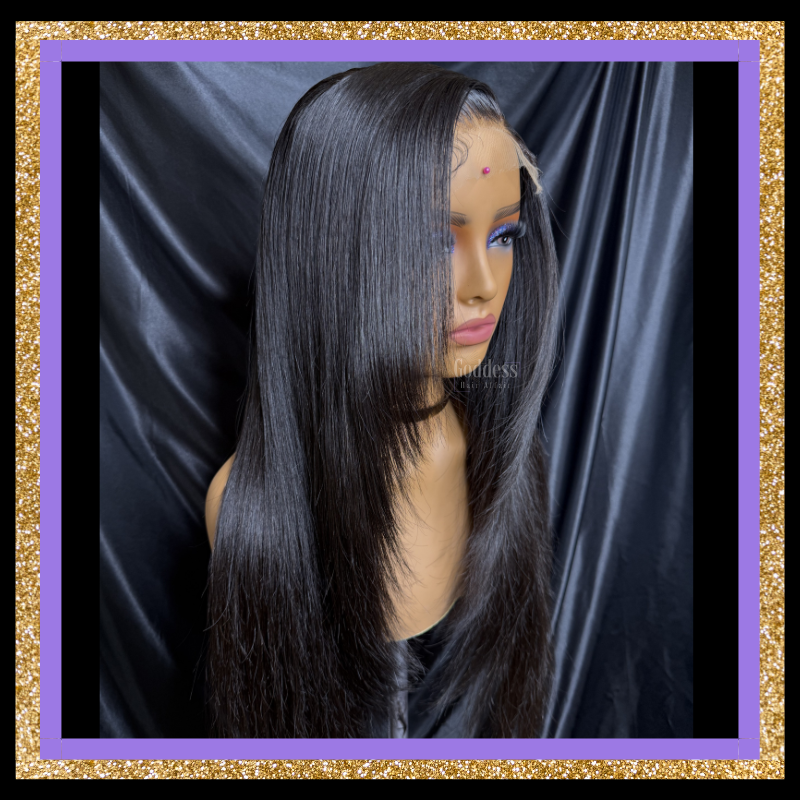 Mannequin head with a black straight wig against a dark background