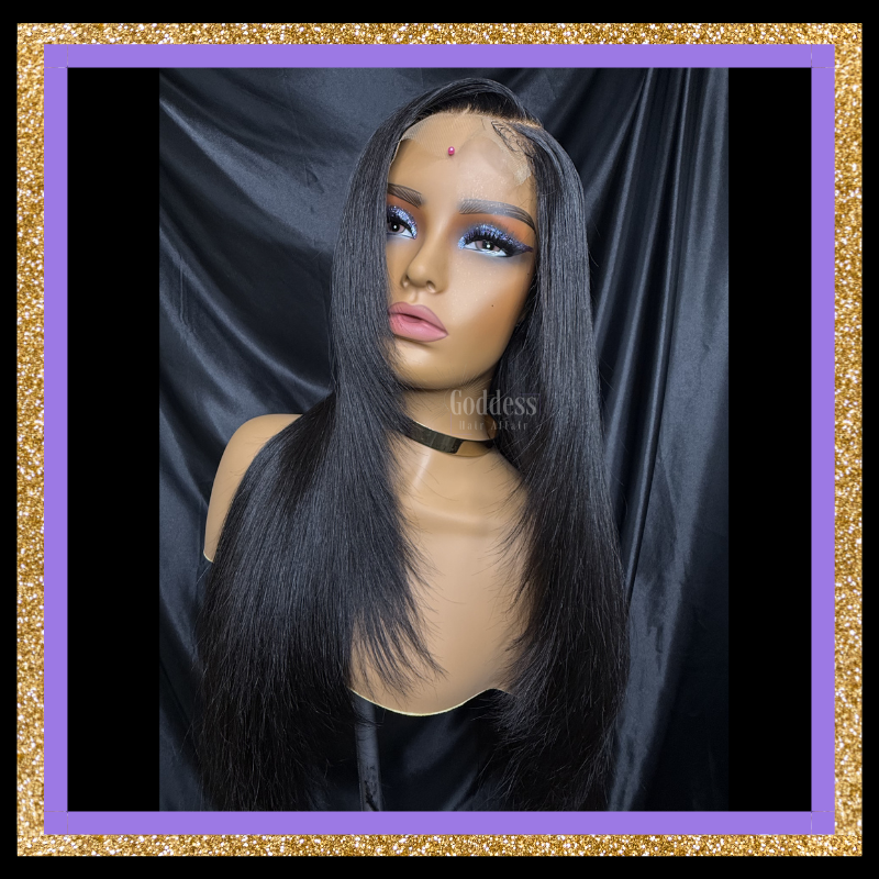 Mannequin head with a black wig against a dark background