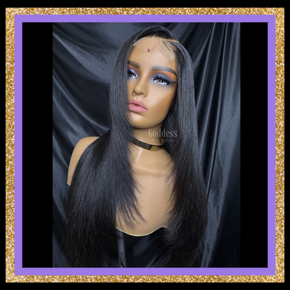 Mannequin head with a black wig against a dark background